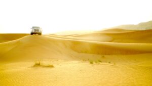 Exploring the red sand desert by SUV